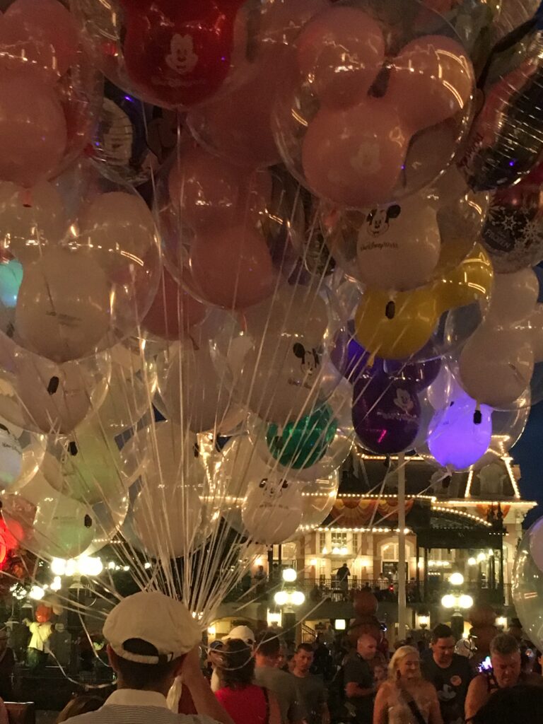 Balloons for sale on Main Street at night