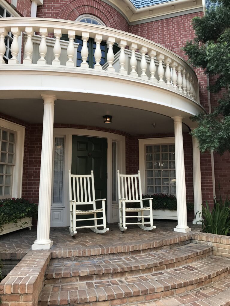 two rocking chairs on brick porch