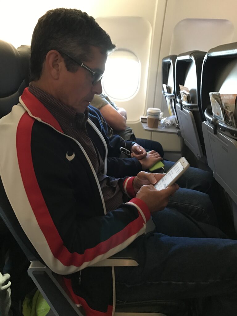 Disney author Jeff Noel writing on a plane